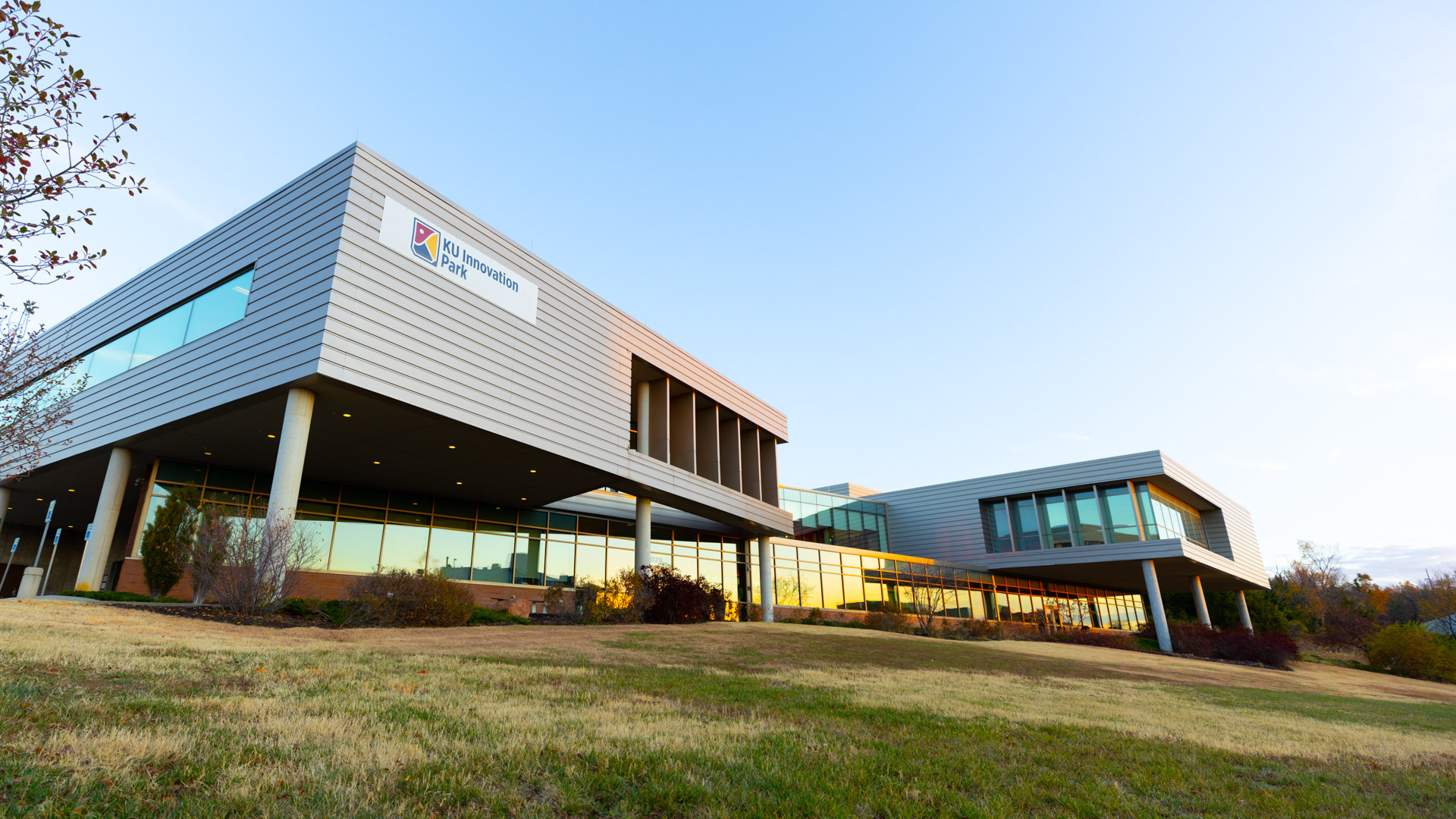 A portrait of the KU Innovation Park building from the grass.