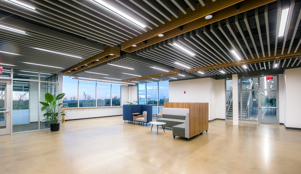 A modern lounge area with overhead lighting at the KU Innovation Park in Lawrence.
